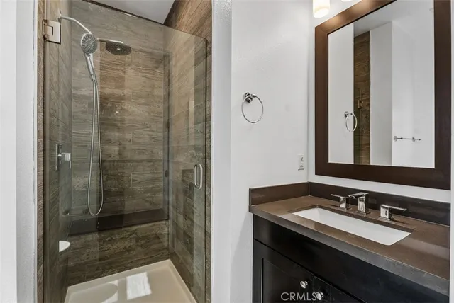 a bathroom with a double vanity sink mirror and toilet