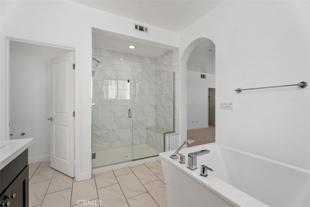 123 Interval Irvine, CA 92618 - Photo 32 of 75 a bathroom with a bathtub and a shower