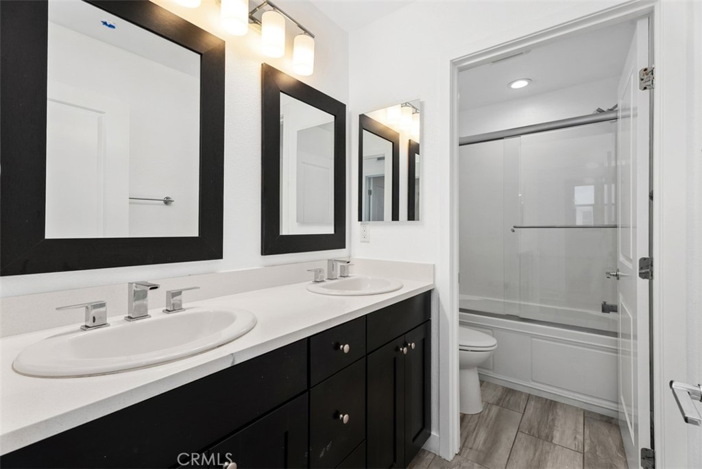 123 Interval Irvine, CA 92618 - Photo 35 of 75 a bathroom with a double vanity sink mirror and toilet