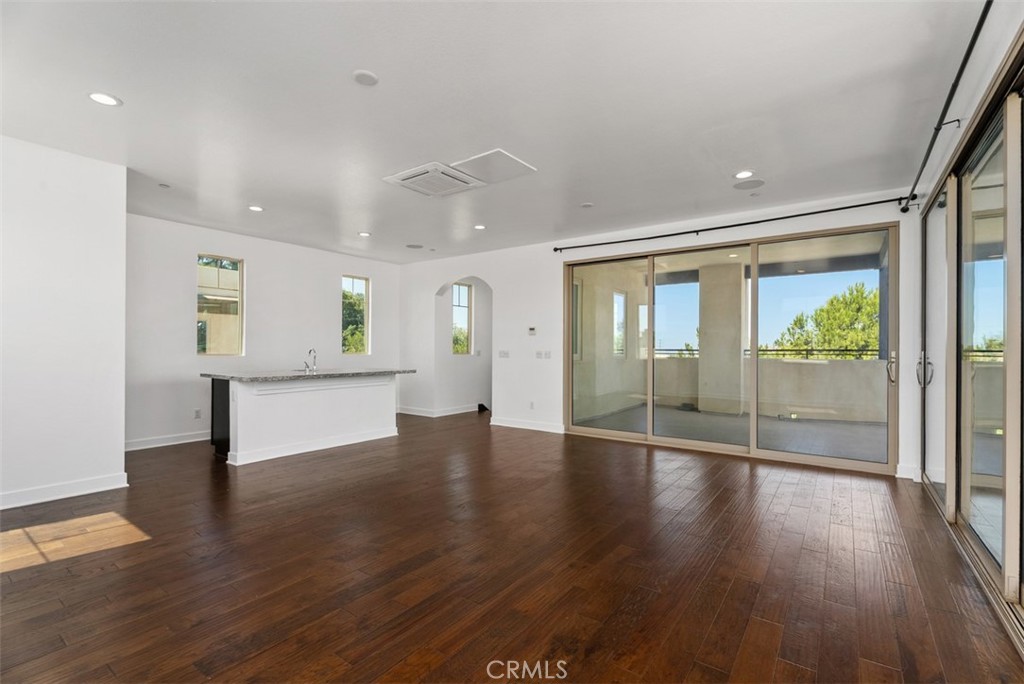 123 Interval Irvine, CA 92618 - Photo 38 of 75 a view of an empty room with wooden floor and a window