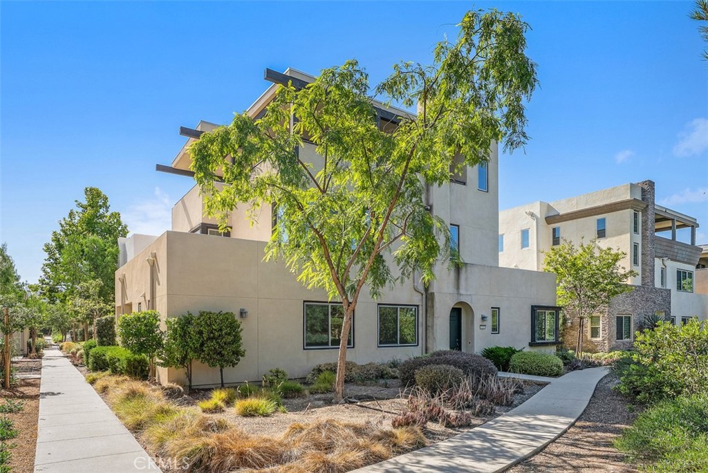 123 Interval Irvine, CA 92618 - Photo 50 of 75 a front view of a house with a yard