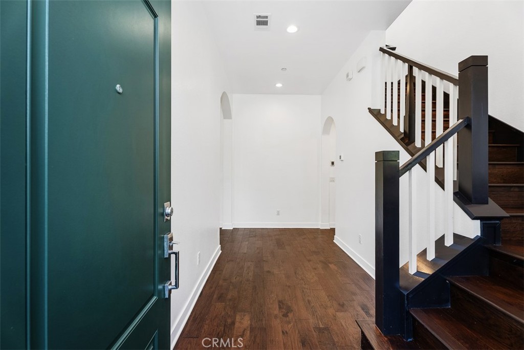 123 Interval Irvine, CA 92618 - Photo 5 of 75 a view of a hallway with wooden floor and staircase