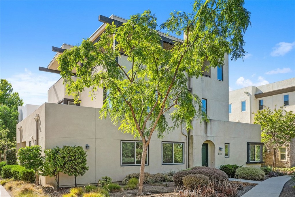 123 Interval Irvine, CA 92618 - Photo 51 of 75 a front view of a house with a garden
