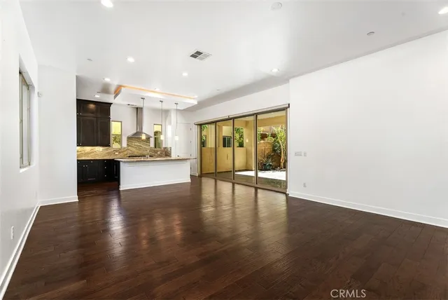 a view of kitchen with kitchen island and stainless steel appliances