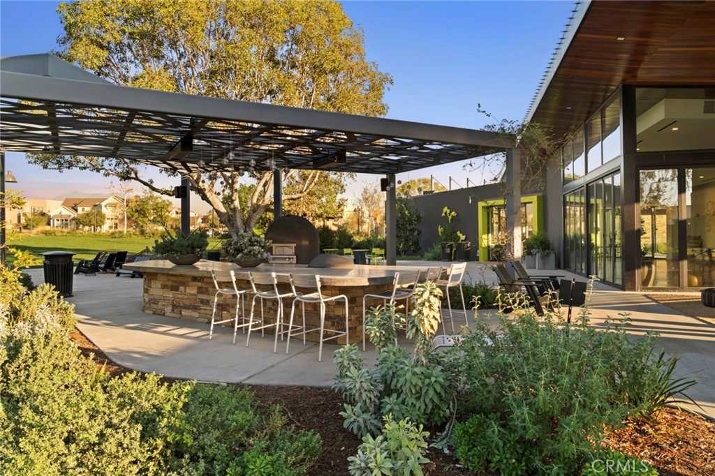 123 Interval Irvine, CA 92618 - Photo 63 of 75 a view of a patio with table and chairs potted plants and large tree