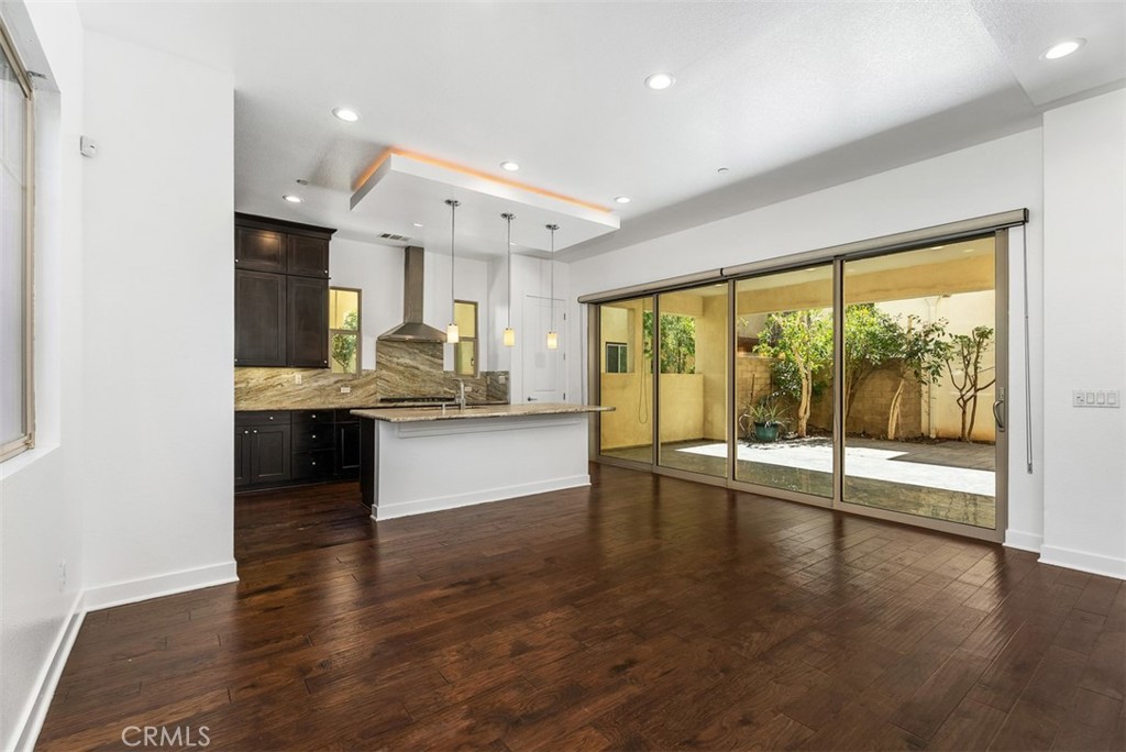 123 Interval Irvine, CA 92618 - Photo 9 of 75 a view of an empty room with kitchen view and a large window
