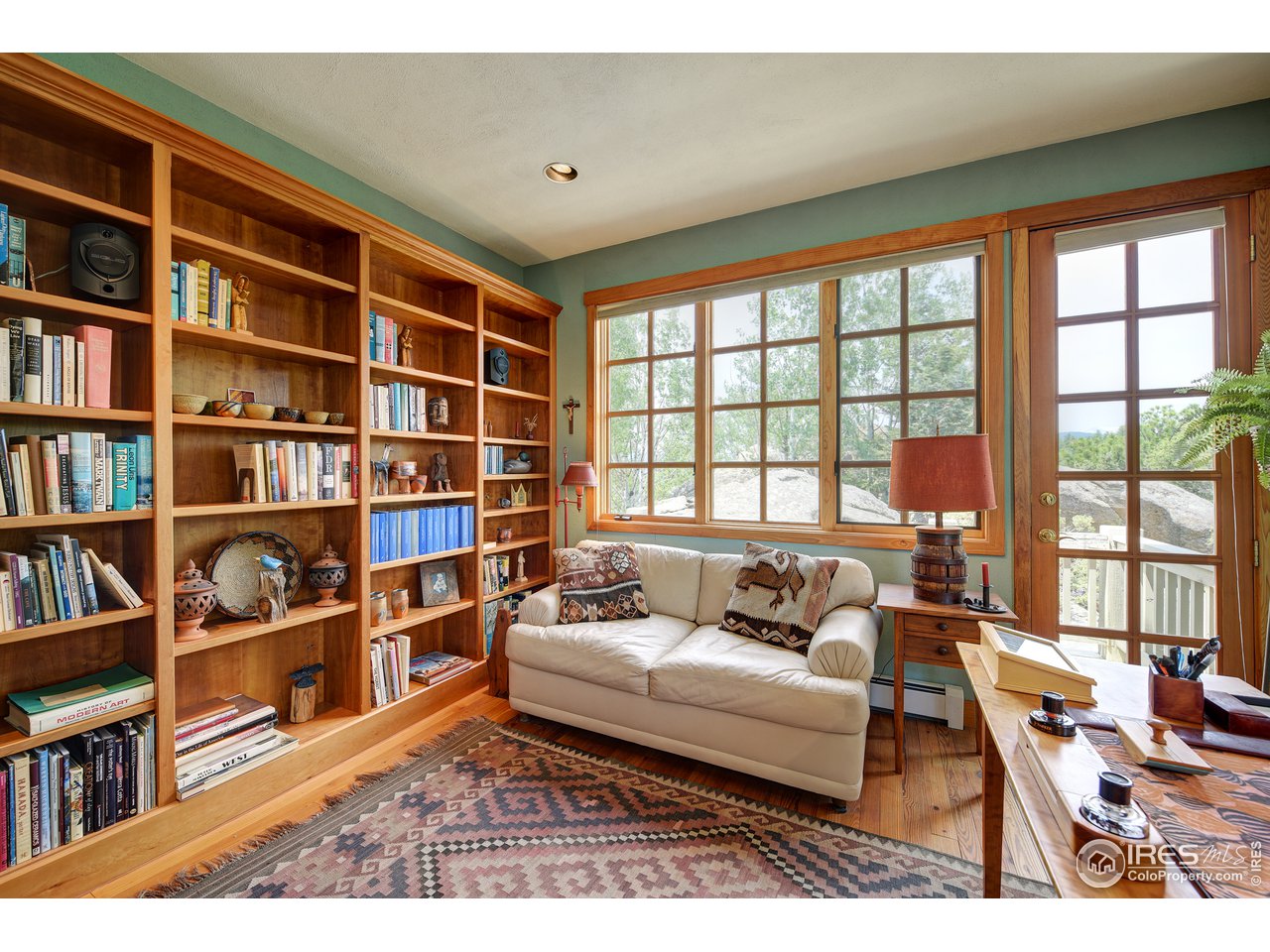 6171 Flagstaff Road Boulder, CO 80302 - Photo 13 of 40 a living room with furniture and a book shelf