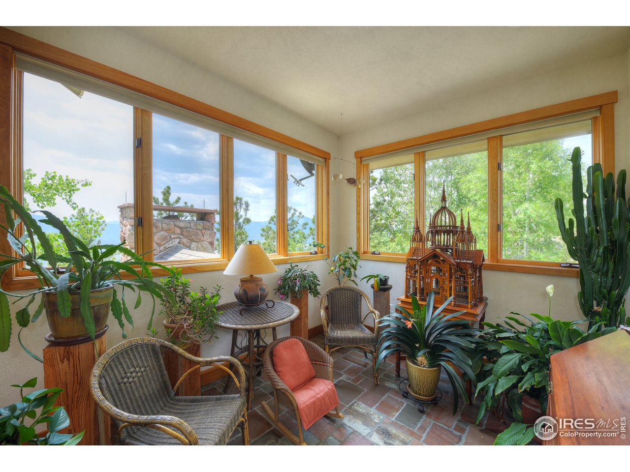 6171 Flagstaff Road Boulder, CO 80302 - Photo 14 of 40 a dining room with furniture potted plants and wooden floor