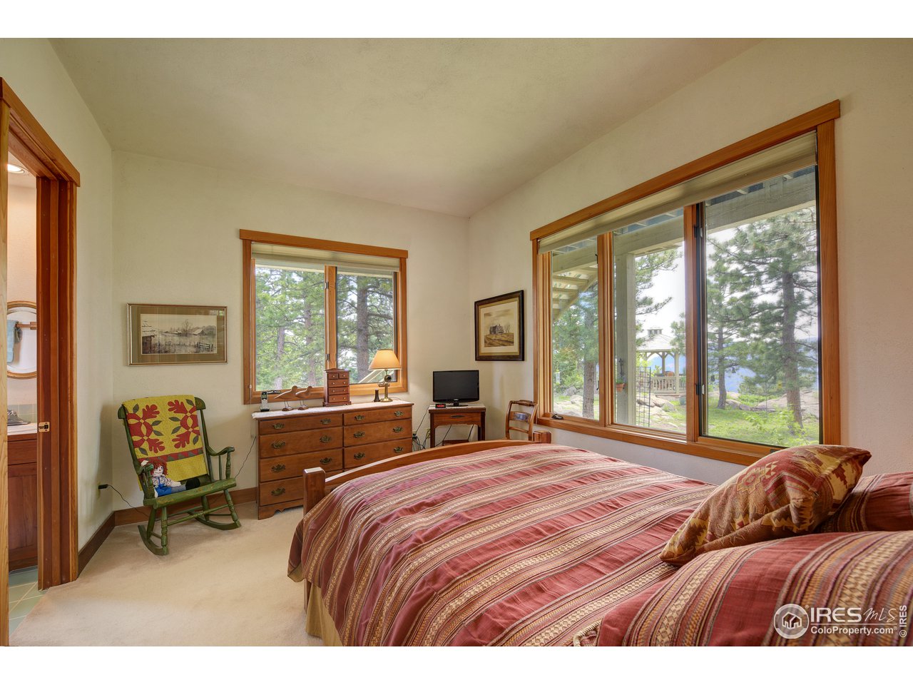 6171 Flagstaff Road Boulder, CO 80302 - Photo 23 of 40 a bedroom with a bed and a large window