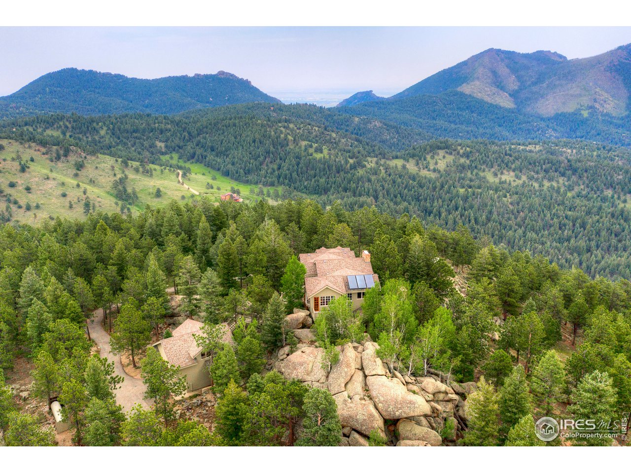 6171 Flagstaff Road Boulder, CO 80302 - Photo 30 of 40 a view of a lush green hillside and a houses