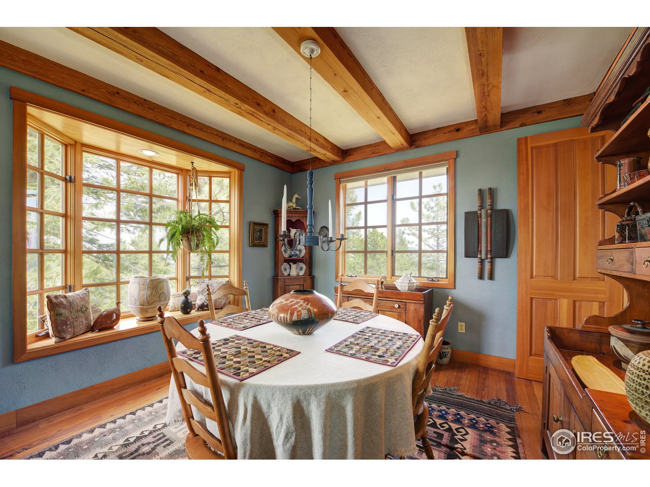 6171 Flagstaff Road Boulder, CO 80302 - Photo 7 of 40 a view of a dining room with furniture large windows and wooden floor