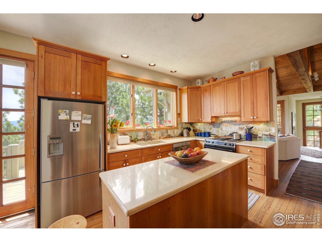 6171 Flagstaff Road Boulder, CO 80302 - Photo 8 of 40 a kitchen with a refrigerator a stove a sink dishwasher and wooden cabinets with wooden floor