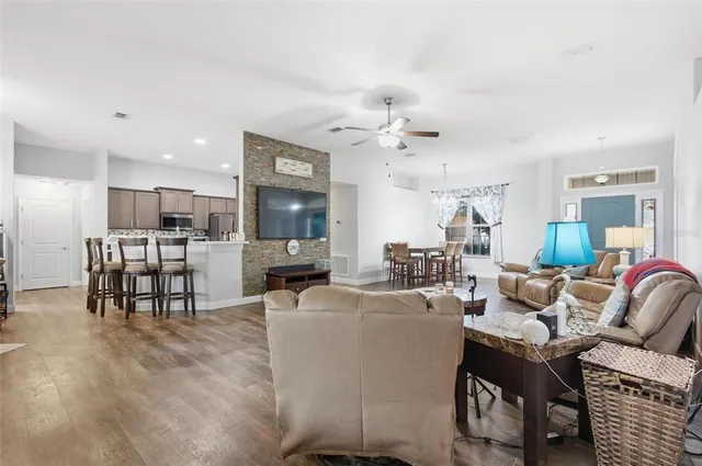 a living room with furniture and kitchen view