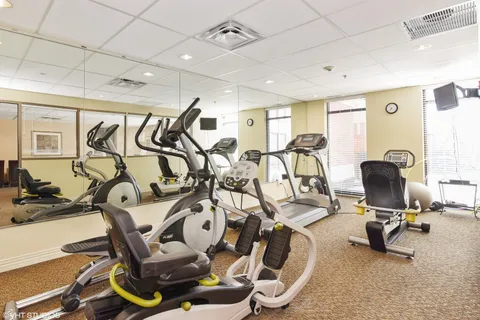 a living room with furniture and gym equipment