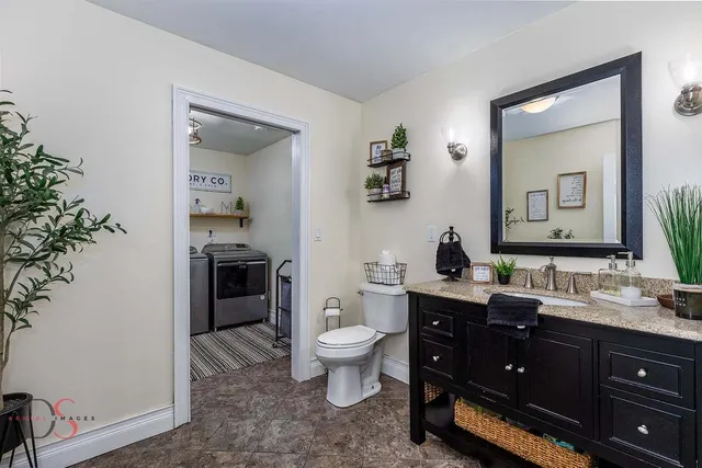 a view of bathroom with a toilet sink and mirror