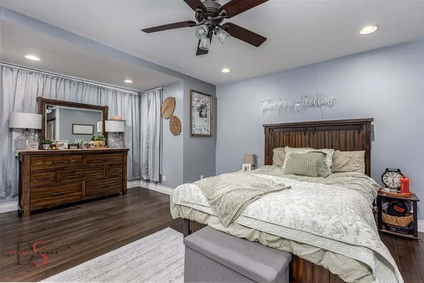 a bedroom with a bed and a dresser