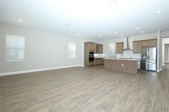a view of kitchen with wooden floor and electronic appliances