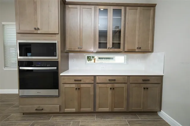 a kitchen with granite countertop a stove and a sink