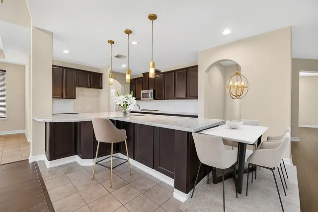 a living room with furniture a wooden floor and a large window