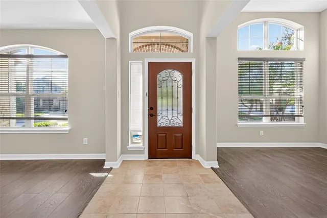 a living room with furniture a rug and a window