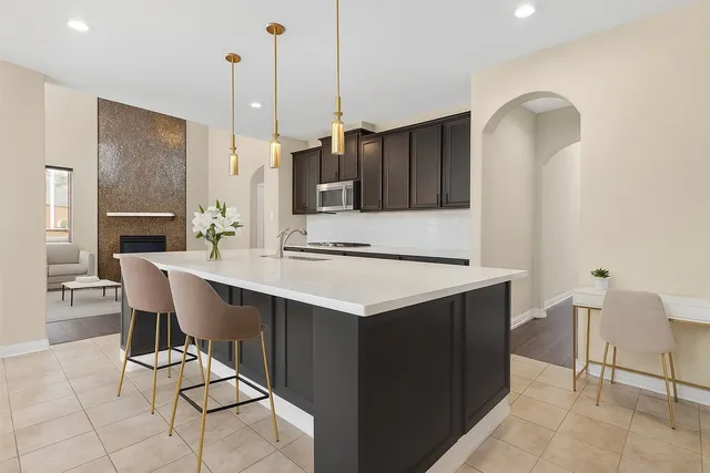 a kitchen with a sink cabinets and wooden floor