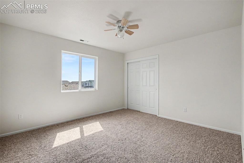 12210 Crystal Downs Road Peyton, CO 80831 - Photo 19 of 40 an empty room with a ceiling fan and a window
