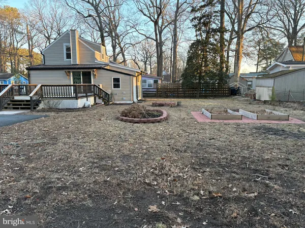 a backyard of house with large trees