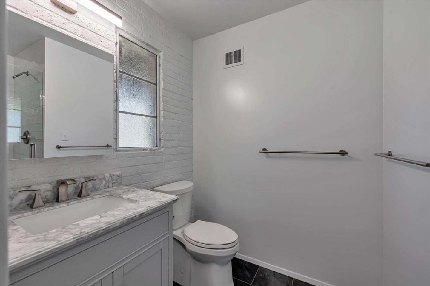 4150 Rincon Circle Palo Alto, CA 94306 - Photo 18 of 32 a bathroom with a granite countertop sink a toilet and a mirror