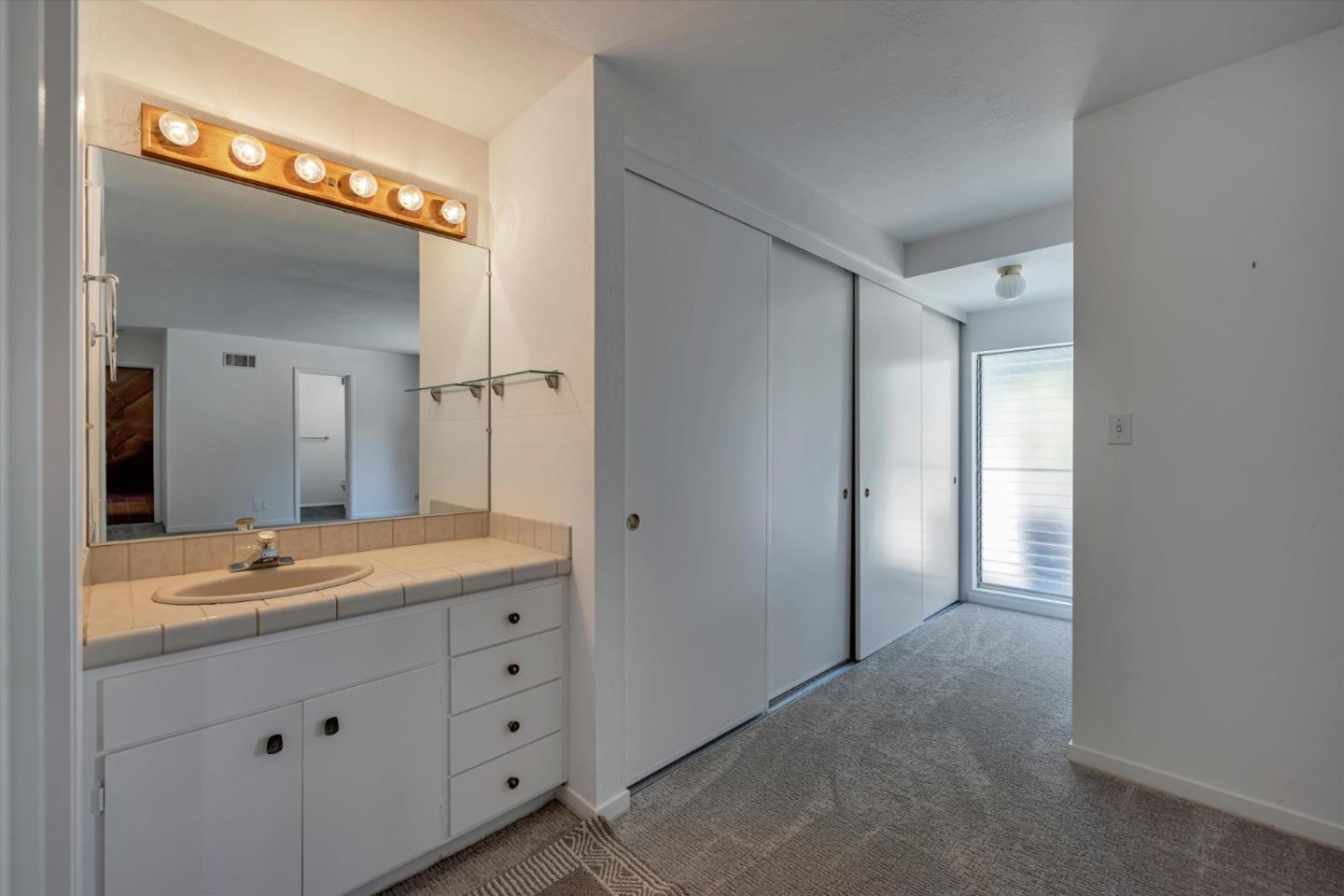 4150 Rincon Circle Palo Alto, CA 94306 - Photo 21 of 32 a bathroom with a granite countertop sink mirror and double