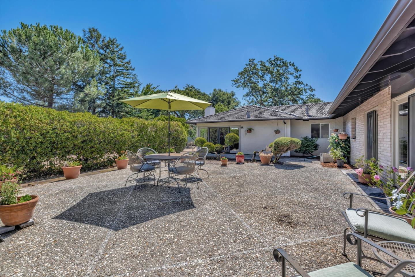 4150 Rincon Circle Palo Alto, CA 94306 - Photo 23 of 32 a view of a patio with table and chairs under an umbrella
