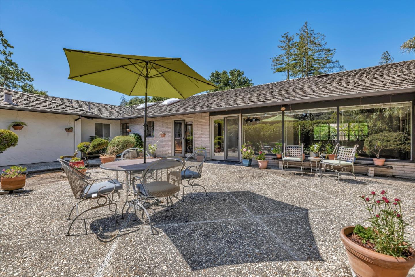 4150 Rincon Circle Palo Alto, CA 94306 - Photo 24 of 32 a view of a patio with table and chairs under an umbrella