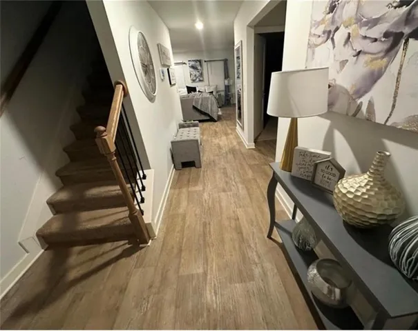 a view of entryway and hall with wooden floor