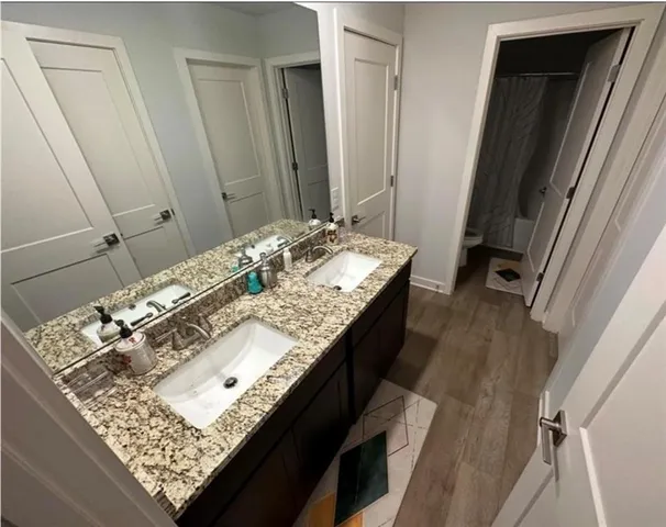 a bathroom with a granite countertop sink and a mirror