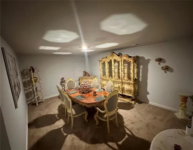 a dining room with furniture and a window