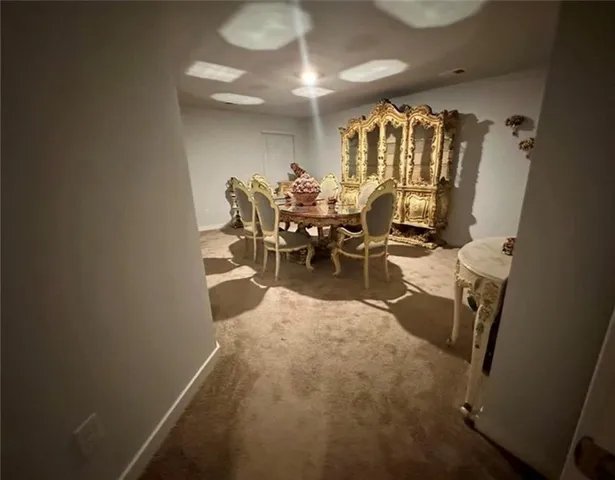 a dining room with furniture and a chandelier