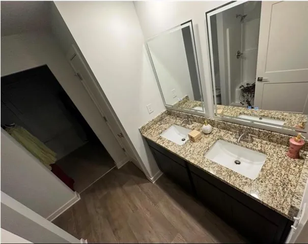 a bathroom with a double vanity sink and mirror