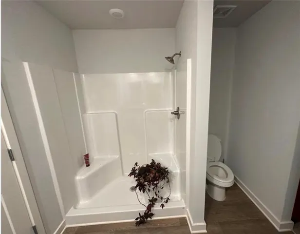 a view of a bathroom with a tub and shower