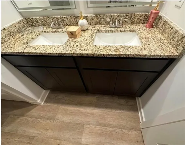 a bathroom with a granite countertop sink and vanity