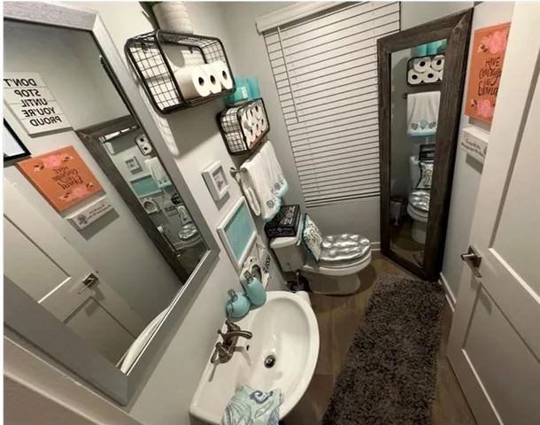 a bathroom with a toilet and a mirror