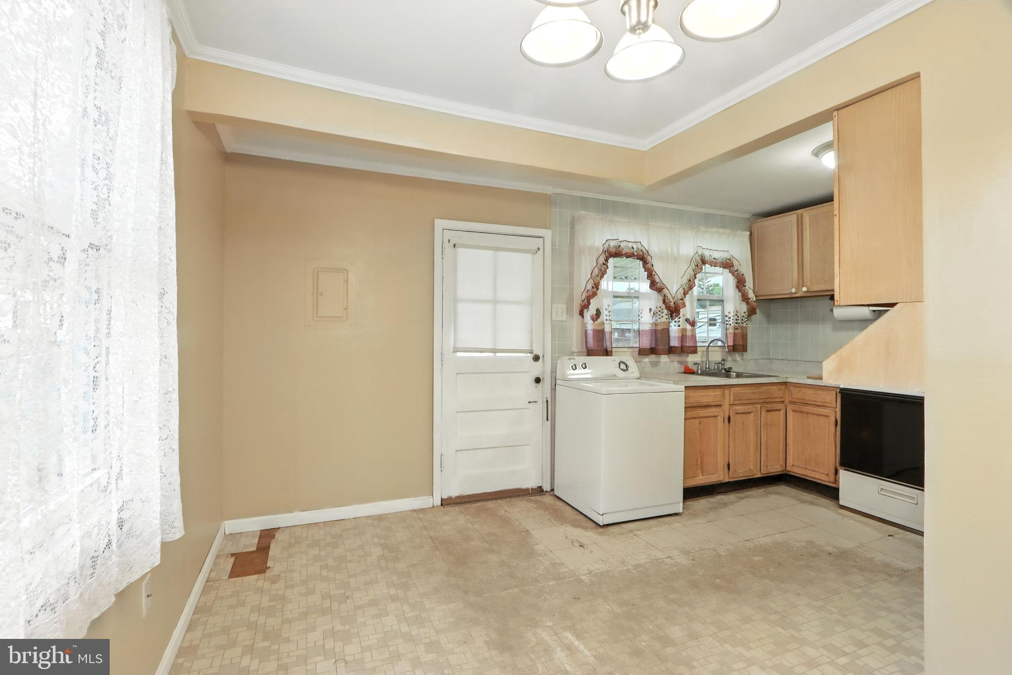 3108 Sollers Point Road Baltimore, MD 21222 - Photo 14 of 41 a room with a cabinets and chandelier