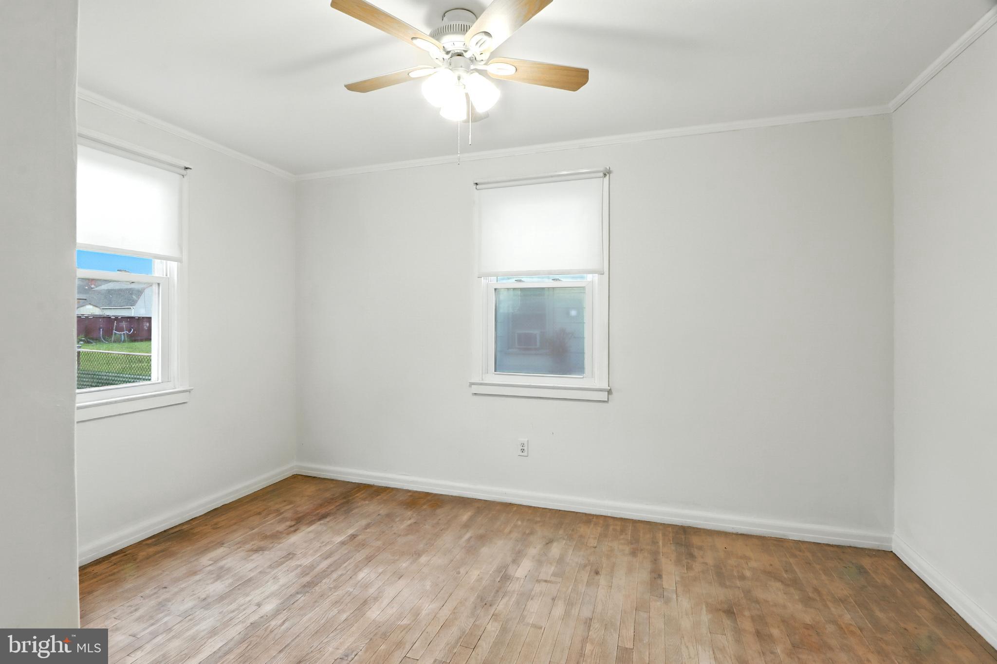 3108 Sollers Point Road Baltimore, MD 21222 - Photo 16 of 41 wooden floor in an empty room with a window