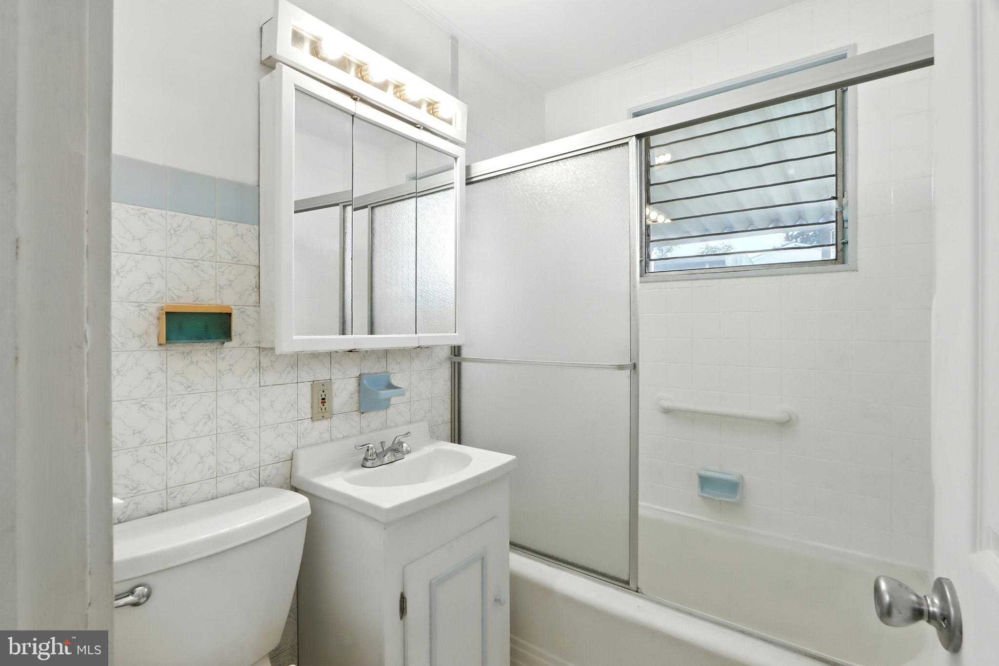 3108 Sollers Point Road Baltimore, MD 21222 - Photo 17 of 41 a bathroom with a sink a toilet and shower