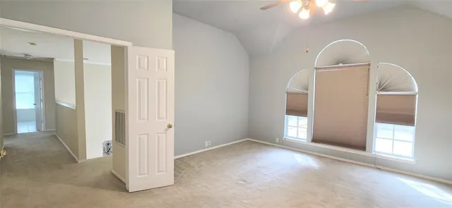 an empty room with windows and closet