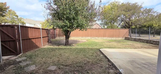 a view of a backyard with a large tree