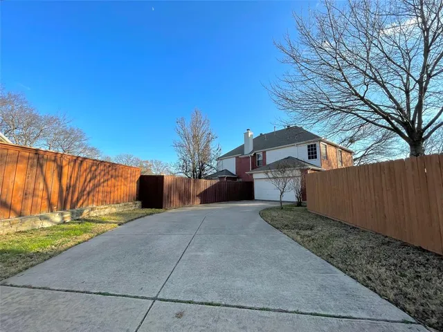a view of a backyard with large trees