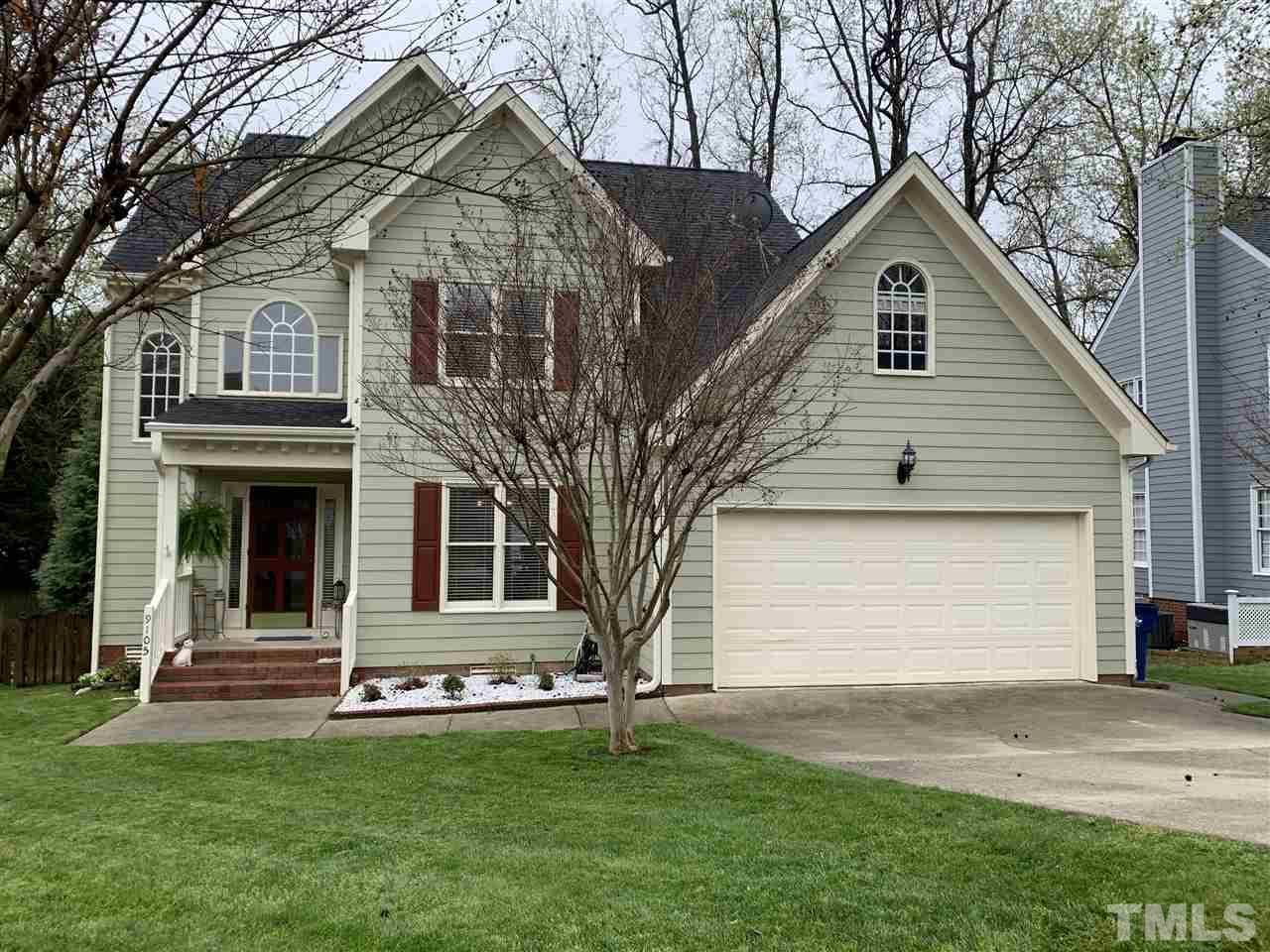 9105 Cub Trail Raleigh, NC 27615 - Photo 1 of 22 a front view of a house with a yard and garage