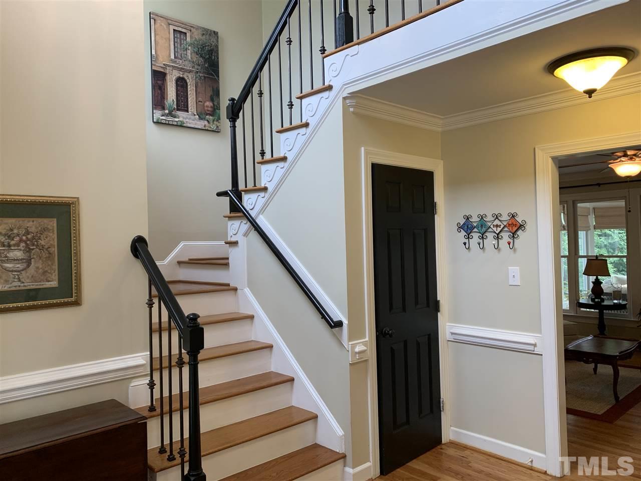 9105 Cub Trail Raleigh, NC 27615 - Photo 2 of 22 a view of staircase with wooden floor and a chandelier