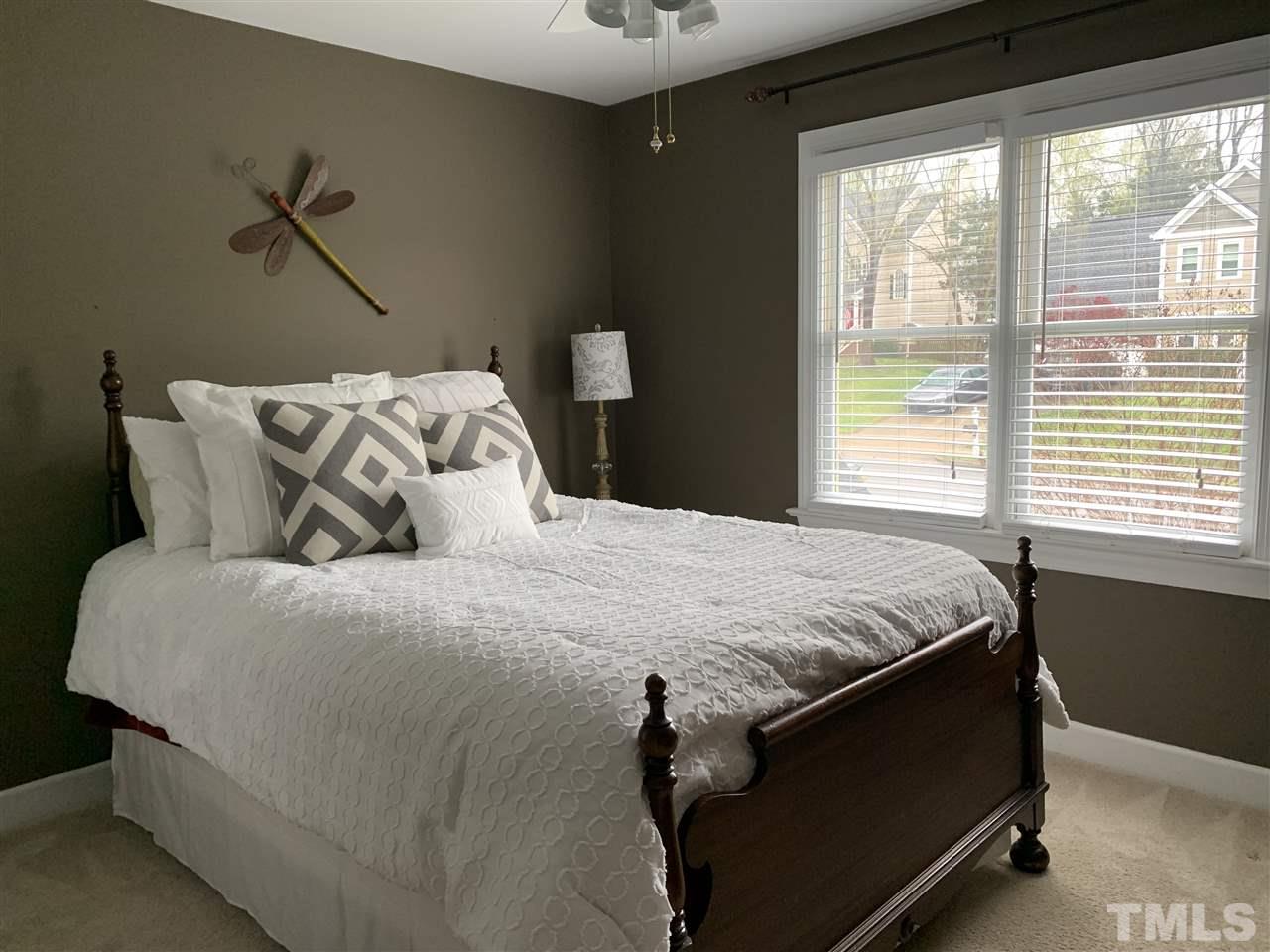 9105 Cub Trail Raleigh, NC 27615 - Photo 14 of 22 a bed sitting in a bedroom next to a window