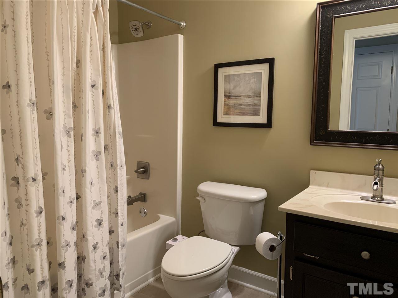 9105 Cub Trail Raleigh, NC 27615 - Photo 15 of 22 a bathroom with a toilet a sink and a shower