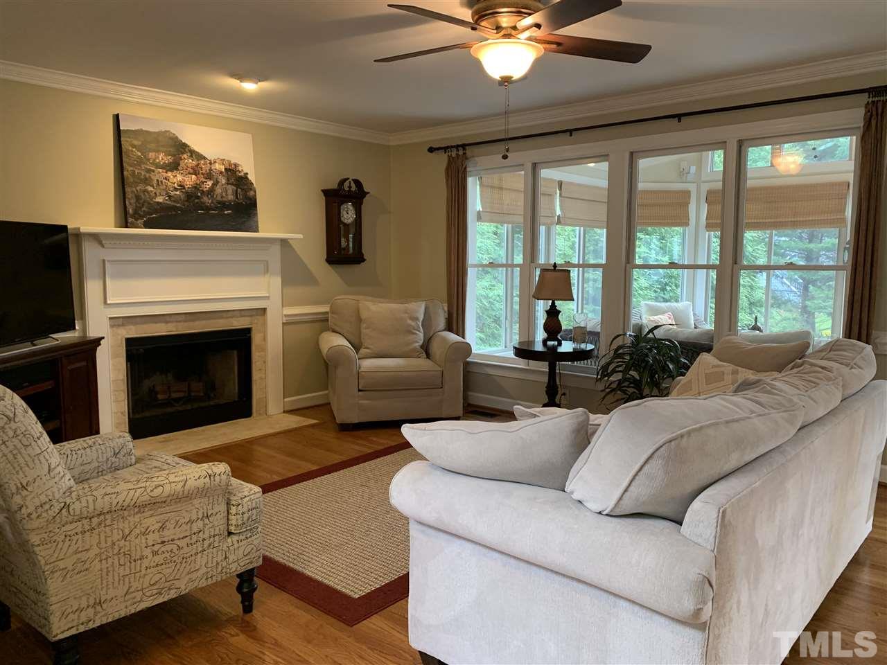 9105 Cub Trail Raleigh, NC 27615 - Photo 3 of 22 a living room with furniture a fireplace and a flat screen tv